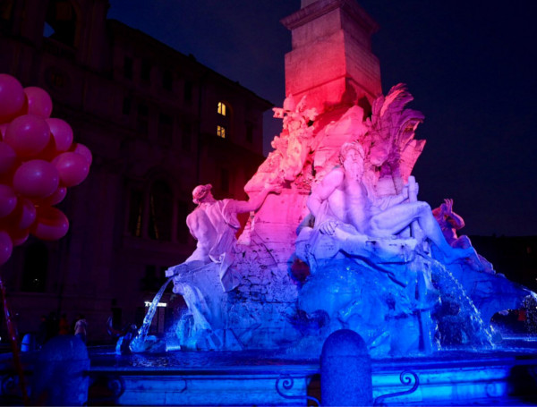 La fontana dei Quattro fiumi di Piazza Navona che si illumina di blu e arancione, i colori della giornata mondiale per la lotta contro il cancro